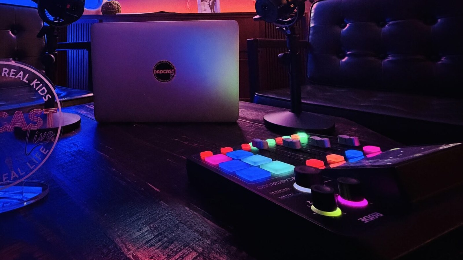 The Dadcast Live studio microphone, warm-lit against the dark of the room